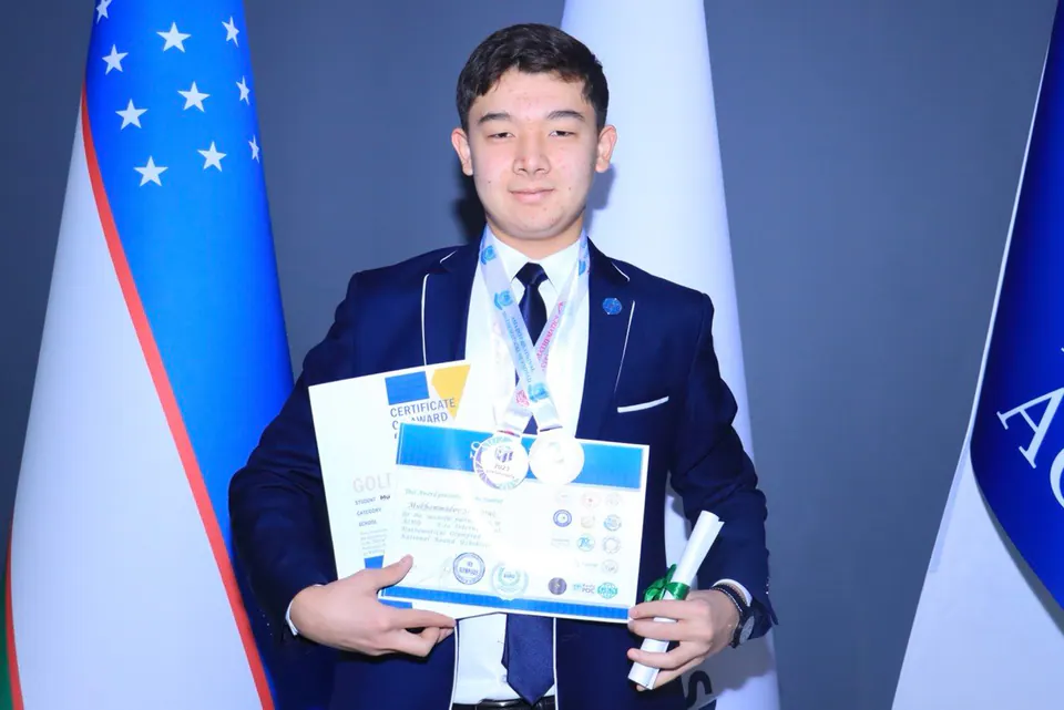 Shokhruz with his medals and certificates