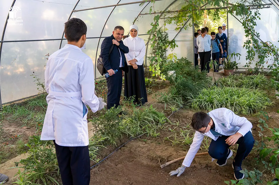 Students and teachers in a Young Farmers greenhouse.